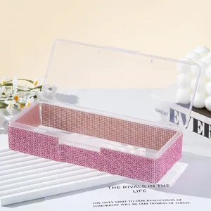 Boîte de rangement pour nail art ornée de strass roses avec un couvercle transparent.