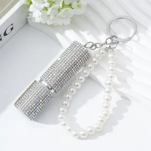 Close-up of luxury 5ml rhinestone perfume atomizer with elegant pearl keychain strap