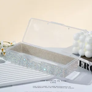 Détail en gros plan d'une boîte de rangement pour bijoux de nail art ornée de strass
