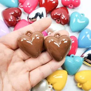 Detailed macro shot of shiny acrylic heart charms for DIY jewelry making accessories.