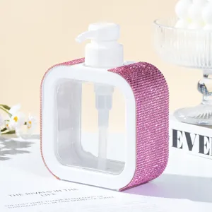 Macro detail of luxurious pink rhinestone pump bottle for refillable bathroom liquid storage.