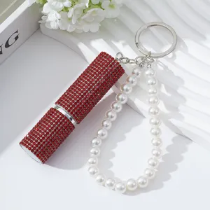 Detail of red rhinestone 5ml perfume atomizer with elegant white pearl wristlet strap