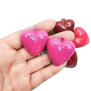 Assorted glossy acrylic heart-shaped charms with hanging holes for DIY jewelry pendants.