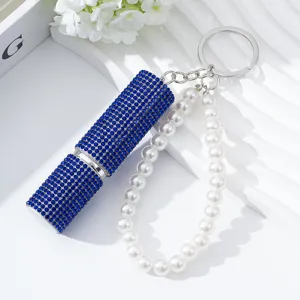 Detailed view of 5ml blue rhinestone perfume atomizer keychain with elegant pearl strap