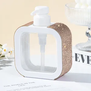 Close-up view of a luxury rhinestone-encrusted white refillable pump dispenser bottle