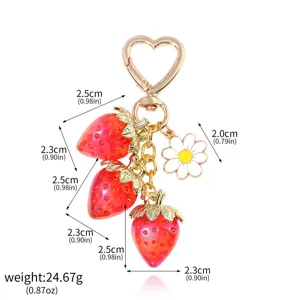 Detail view showing dimensions of translucent strawberry keychain with daisy and heart clasp