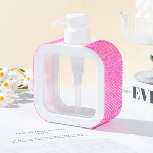Close-up detail of luxury square refillable pump bottle with pink rhinestone accents