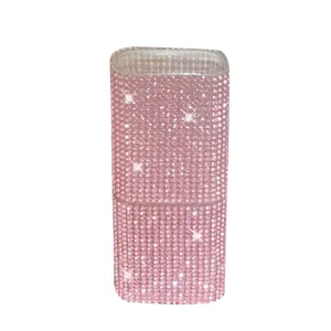 Close-up of a portable storage box covered in glittering pink rhinestones