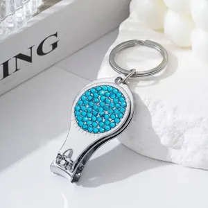 Close-up detail of the sparkling blue rhinestones on the multipurpose nail clipper tool