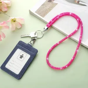 Detail view of sparkling pink glitter lanyard with denim card holder and key ring.