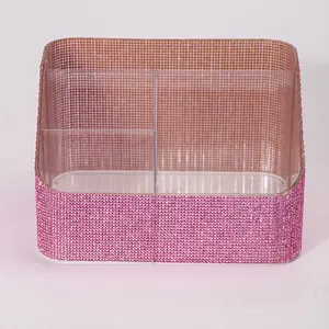 Detailed macro view of a pink rhinestone-encrusted acrylic makeup brush storage box