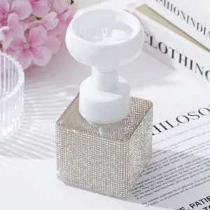 Close-up of elegant flower-shaped pump head on rhinestone-encrusted foaming bottle