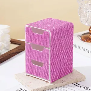 Macro view of a luxury pink rhinestone-covered three-tier drawer jewelry organizer