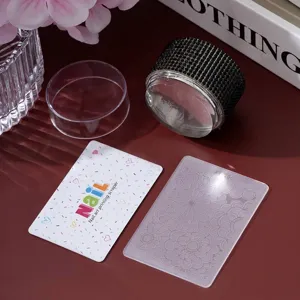 Close-up detail of rhinestone-decorated nail stamper kit with scraper and floral plate