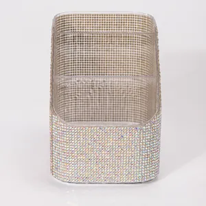 Close-up of a three-compartment desk organizer fully covered in sparkling iridescent AB rhinestones.