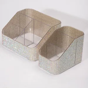 Sparkling rhinestone makeup brush and nail art organizer set on white background.