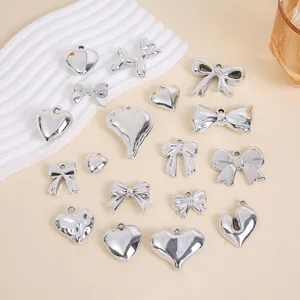 Variety of silver heart and bow charms for DIY jewelry making with smooth metallic finish