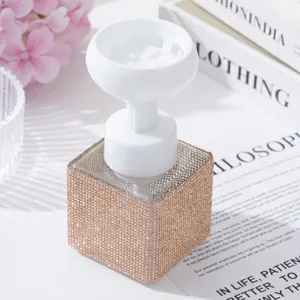 Detail of luxurious rhinestone foaming bottle with white flower pump dispenser head