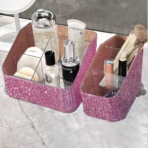 Pink rhinestone vanity organizer with multiple grids shown on a marble surface.