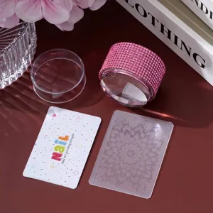 Detail view of the pink rhinestone nail art stamper kit with scraper and mandala plate