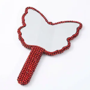 Specchio cosmetico a mano a forma di farfalla con bordo in strass rossi scintillanti