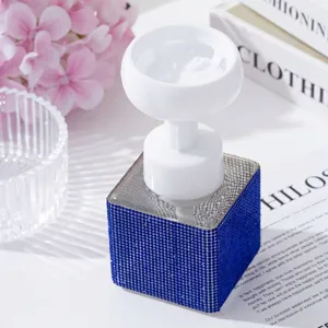 Macro view of blue rhinestone foam dispenser bottle with flower-shaped pump head