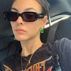 Neon green safety pin earrings in a stylish ins-inspired fashion lifestyle look for women.