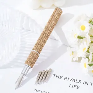 Close-up detail view of a luxury rhinestone nail art pen with 5 interchangeable metal nibs.