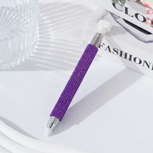 Detail of purple rhinestone nail dotting pen with wax tip for crystal picking