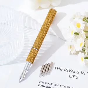 Detailed view of luxury gold rhinestone nail art pen with five replaceable metal tips.