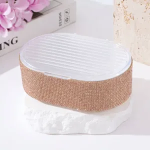 Close-up of rhinestone-studded soap box with transparent ribbed lid for bathroom decor