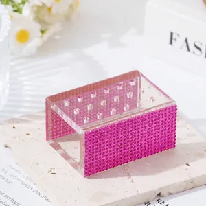 Detailed macro view of the pink rhinestone 18-hole acrylic nail drill bit storage box