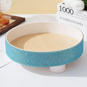 Detailed close-up of a circular tray featuring a light blue rhinestone studded border.