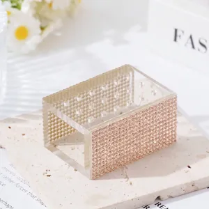 Detailed view of an 18-hole acrylic nail drill bit box with rose gold rhinestones