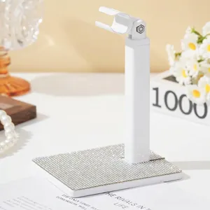 Detail van witte nagellampstandaard met fonkelende strass-basis en draaibare kop