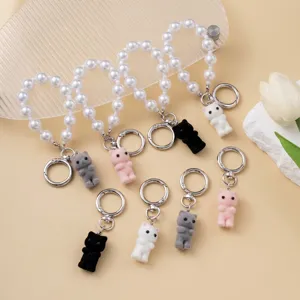 Detail of cute flocked cat charms with heart-shaped pearl chains in multiple colors.