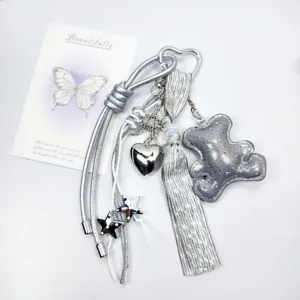 Silver leather bear keychain with metallic heart and star charms