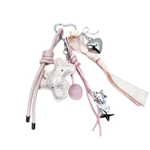 Pink leather keychain charm with sparkling bear, silver heart, and stars