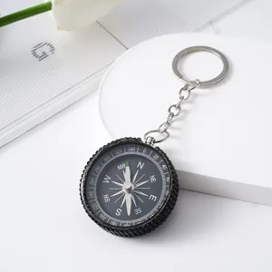 Detailed view of rhinestone-studded aluminum compass keychain for outdoor navigation