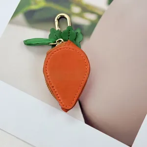 Close-up detail of carrot-shaped PU leather mini coin purse and earphone case.