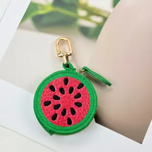 Detailed close-up of a cute watermelon-shaped PU leather coin purse with a premium golden clasp.
