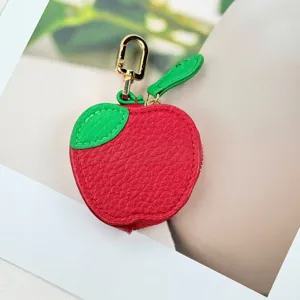 Mini apple-shaped PU leather coin purse and headphone case with a golden carabiner.