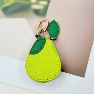 Close-up of a pear-shaped PU leather pouch showing lychee grain texture and gold metal clip