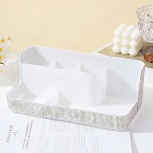 Detailed view of white rhinestone nail tool organizer with multiple compartments