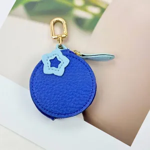 Close-up view of a blue PU leather mini coin purse featuring a light blue star charm