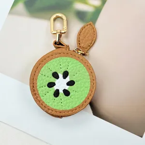 Close-up of a cute kiwi fruit shaped PU leather mini pouch with gold zipper and hook.
