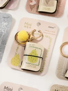 Mini pear pendant book keychain detail, cute PU leather mini notebook with yellow pompom charm.