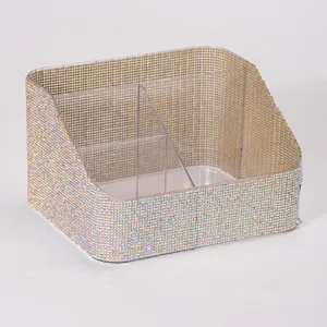Close-up of a multi-grid storage box fully covered in sparkling iridescent rhinestones