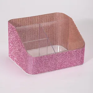 Detailed view of pink rhinestone makeup brush organizer with three clear compartments