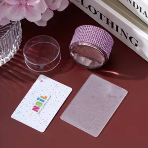 Close-up detail of a pink rhinestone nail art stamper set with a floral etching plate